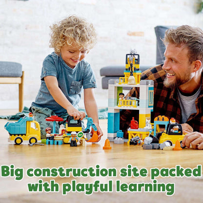 Child and adult play at a large LEGO DUPLO construction site set, engaging in creative, playful learning activities.