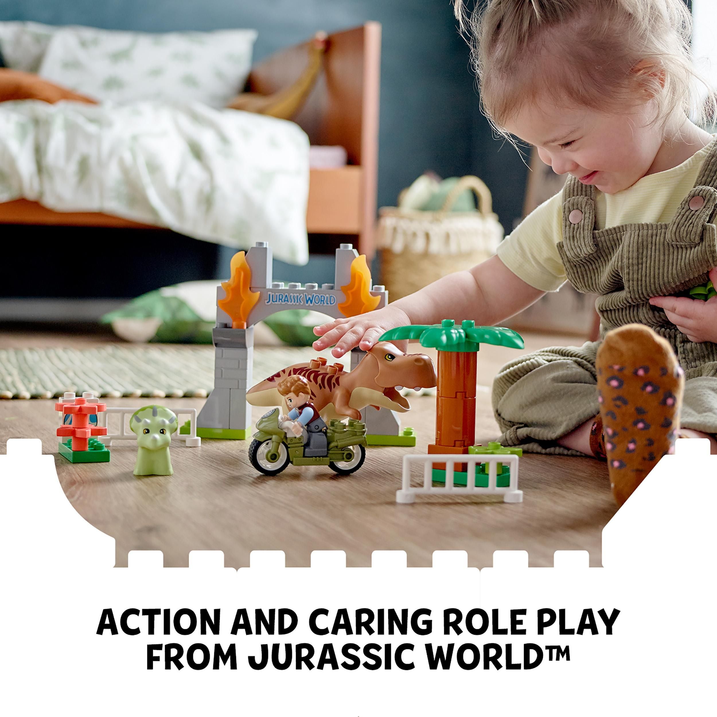 Child playing with LEGO® DUPLO Jurassic World T. rex and Triceratops set in a vibrant playroom.
