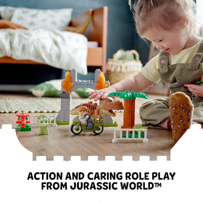 Child playing with LEGO® DUPLO Jurassic World T. rex and Triceratops set in a vibrant playroom.