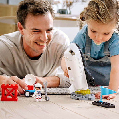 Father and daughter playing with LEGO® DUPLO Space Shuttle Mission Set, enhancing creativity and developmental skills.