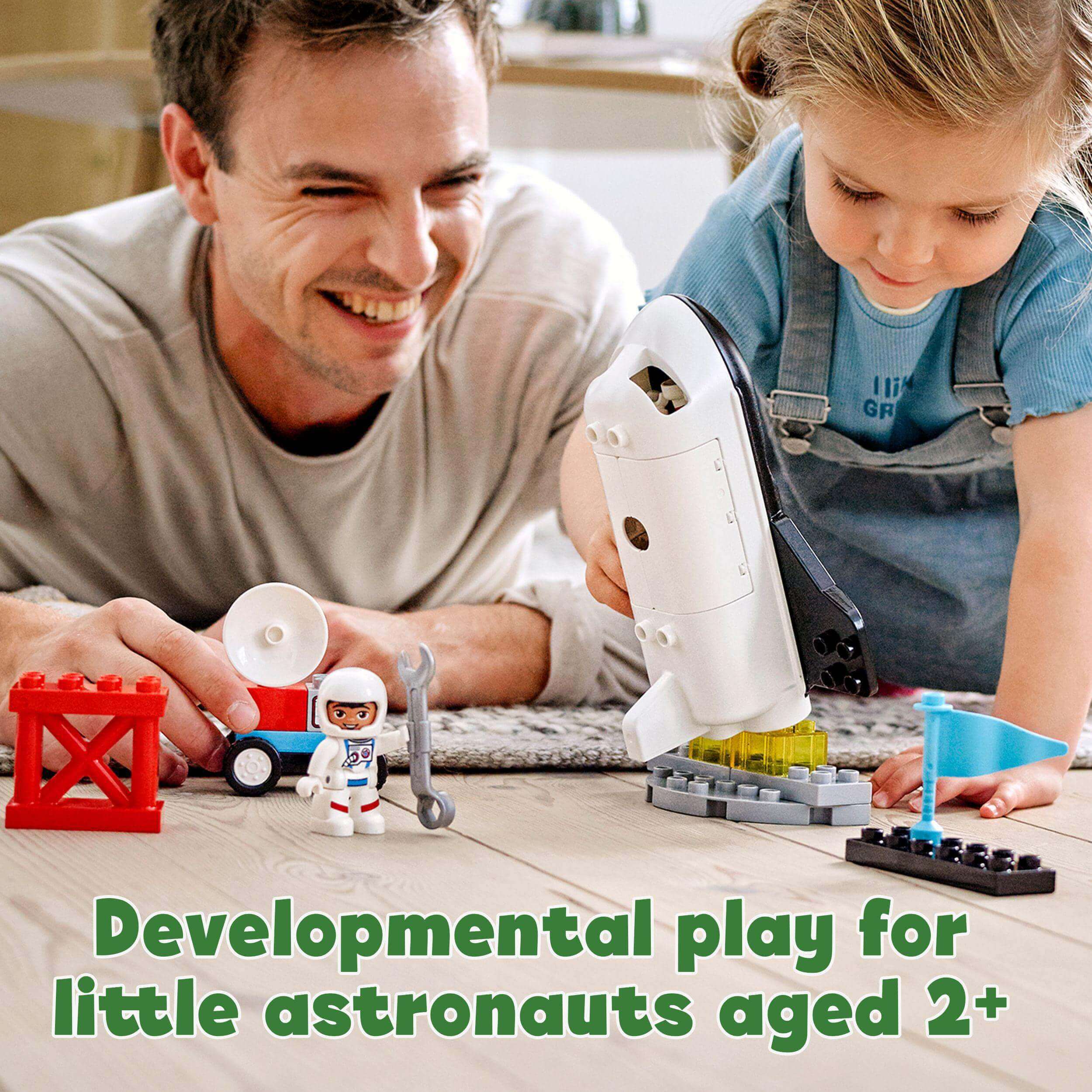 Father and child playing with LEGO® DUPLO Space Shuttle Mission Set, fostering developmental skills for toddlers 2+.