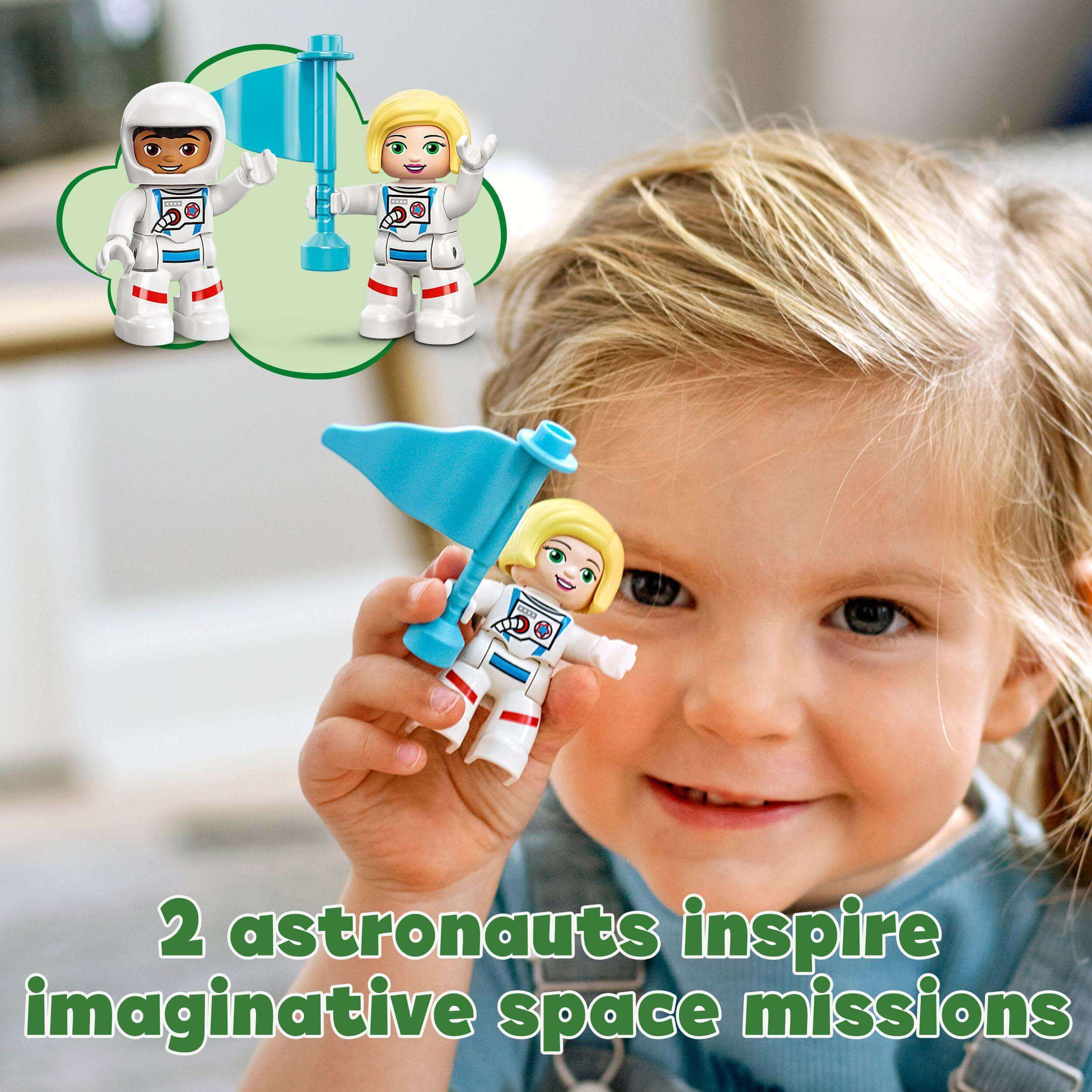 Toddler with LEGO DUPLO astronauts holding a blue flag, sparking imaginative space missions and development skills.