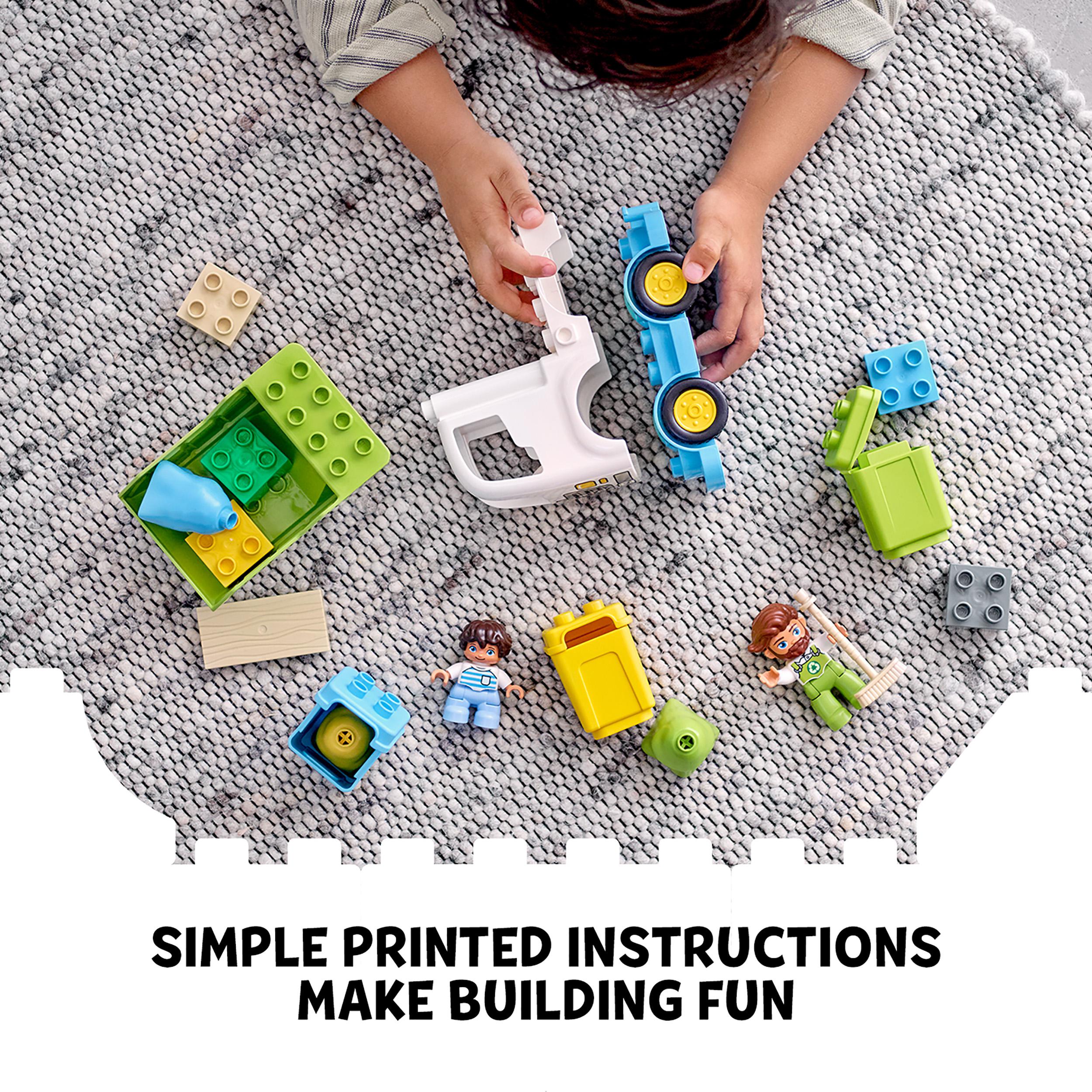 Child playing with LEGO DUPLO recycling truck set, featuring colorful blocks and simple instructions on a play mat.