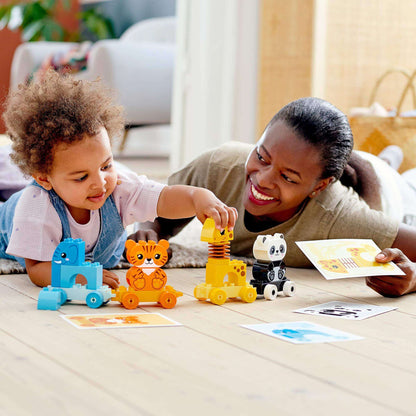 Child and parent enjoying LEGO® DUPLO My First Animal Train Toy 10955, learning about animals while playing together.