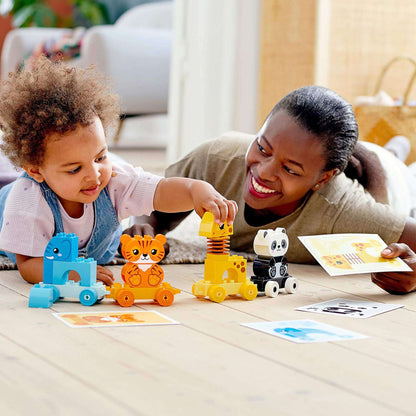 A child and a parent playing with LEGO® DUPLO My First Animal Train Toy, featuring colorful animal figures and educational activities.