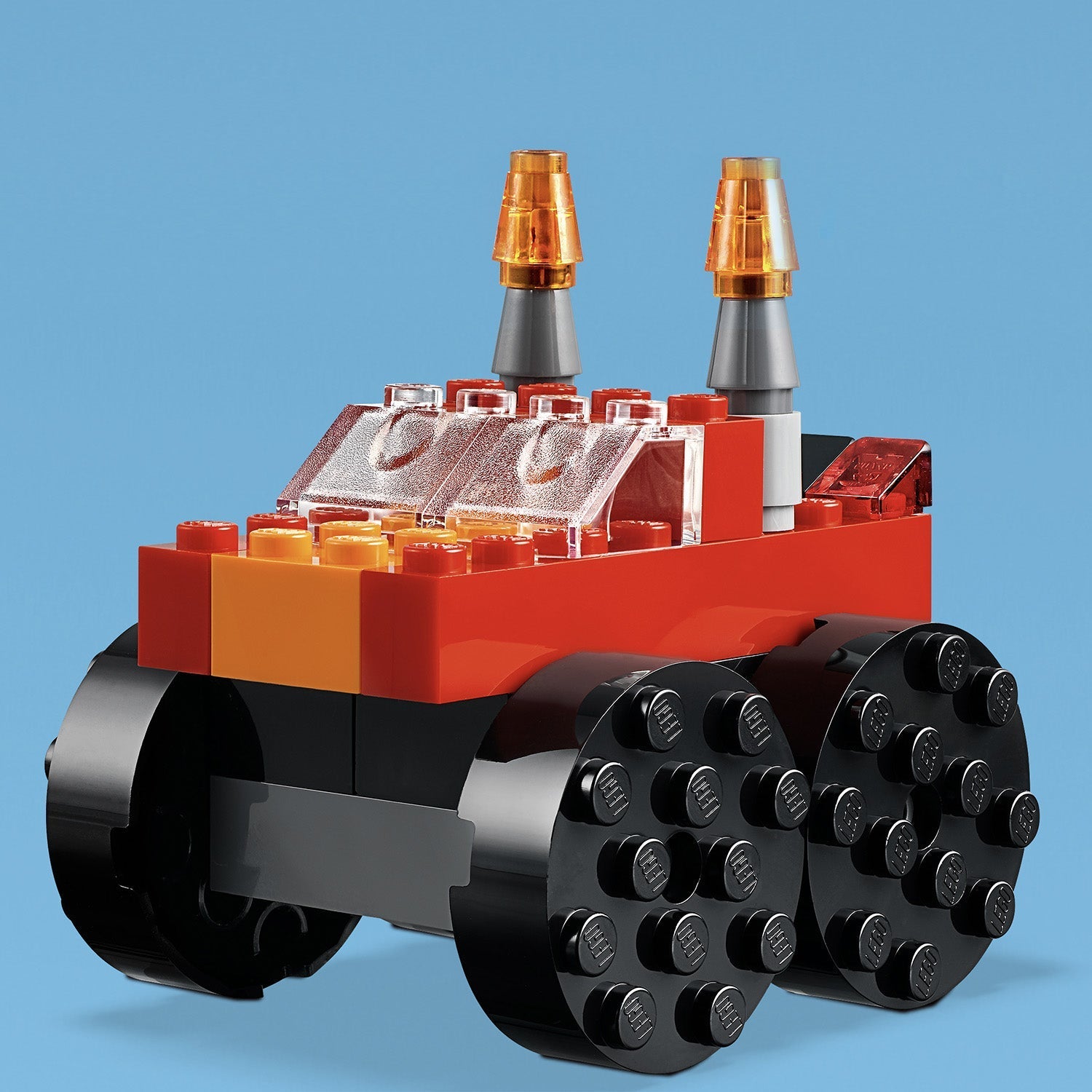 LEGO Classic Basic Brick Set toy vehicle in vibrant red and black, featuring unique wheels and antennas.