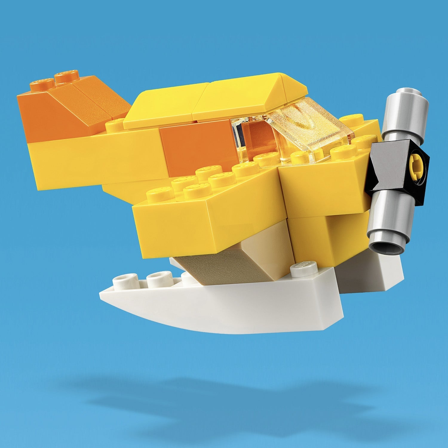 LEGO Classic Basic Brick Set 11002: Creative yellow airplane model built with colorful bricks.