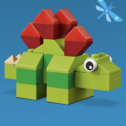 LEGO® Classic Basic Brick Set dinosaur model in green and red on blue background, perfect for building creativity.