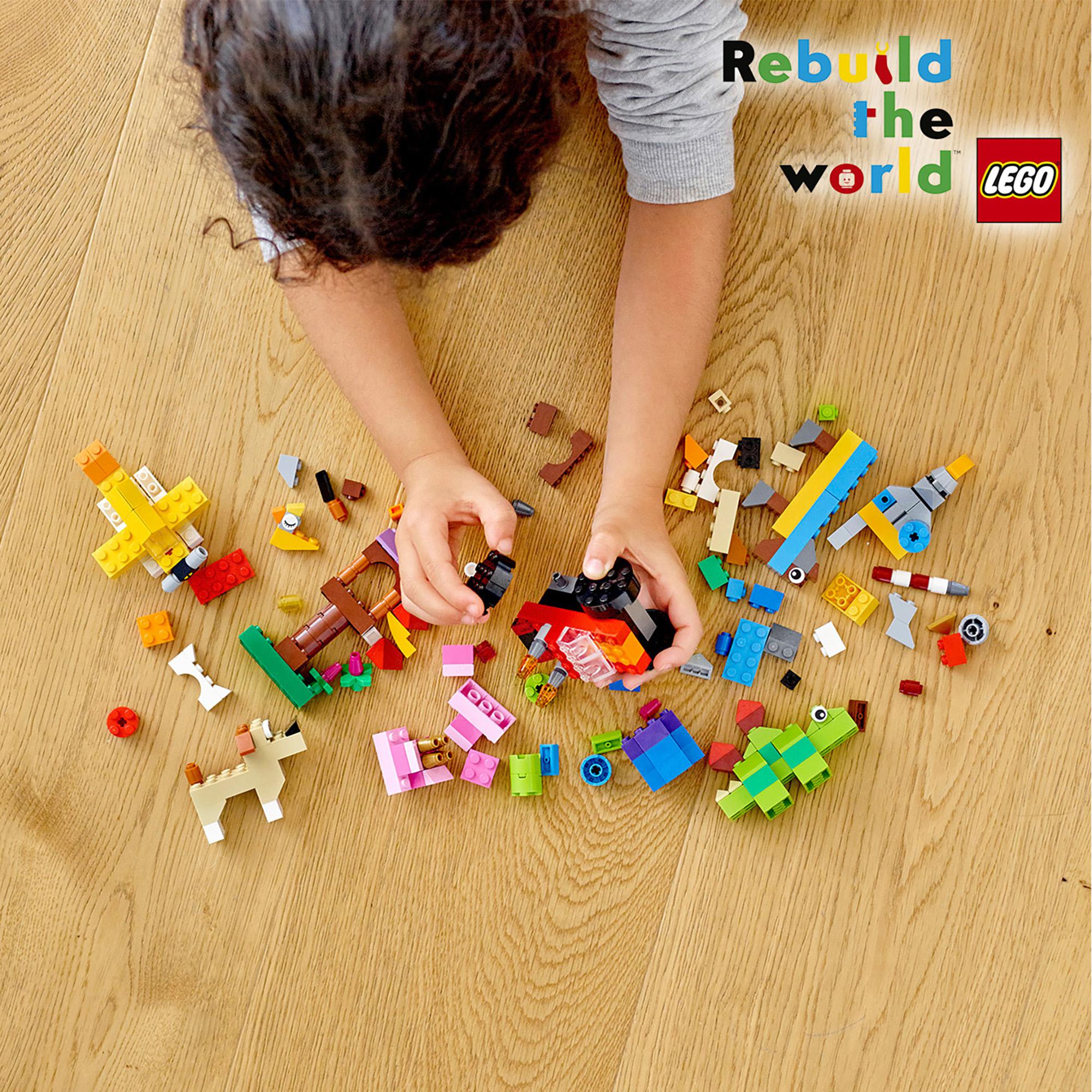 Child building with colorful LEGO bricks, promoting creativity and fun with the LEGO Classic Basic Brick Set 11002.