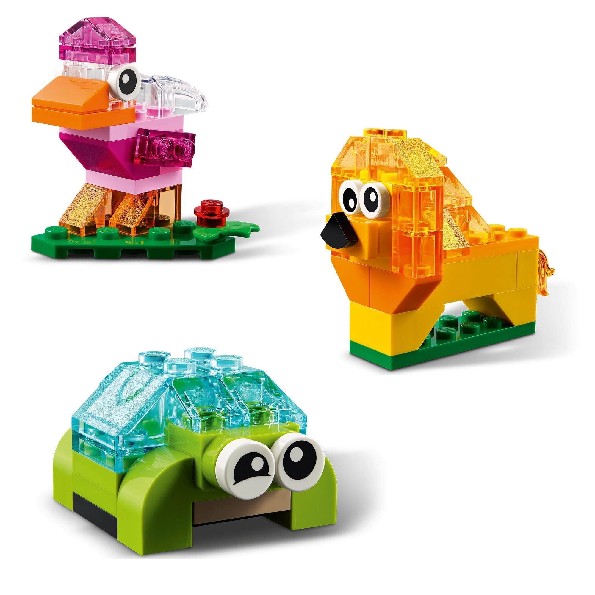 Colorful LEGO® models including a bird, lion, and turtle made from transparent bricks for creative play.