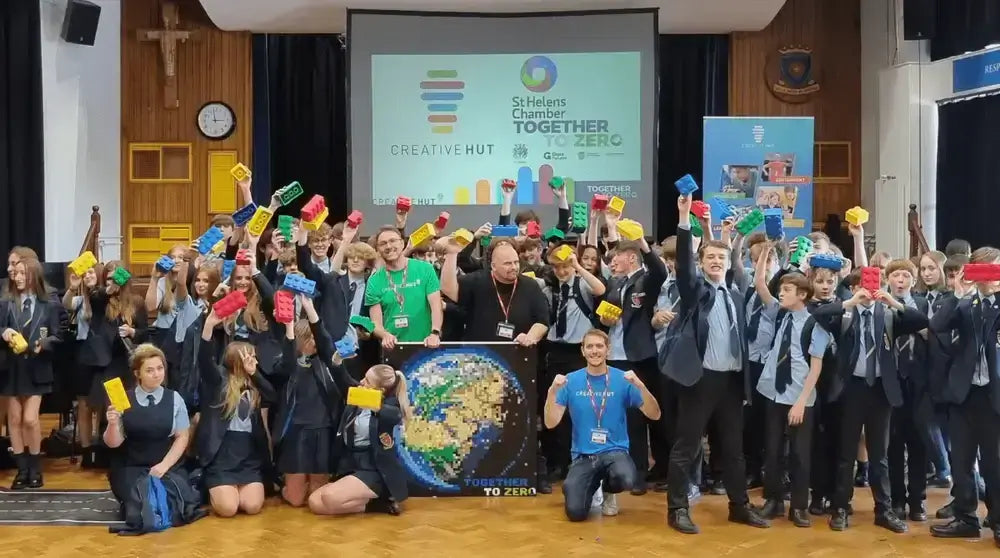 Students and mentors celebrating at the Together to Zero event with colorful blocks, promoting creativity and teamwork.