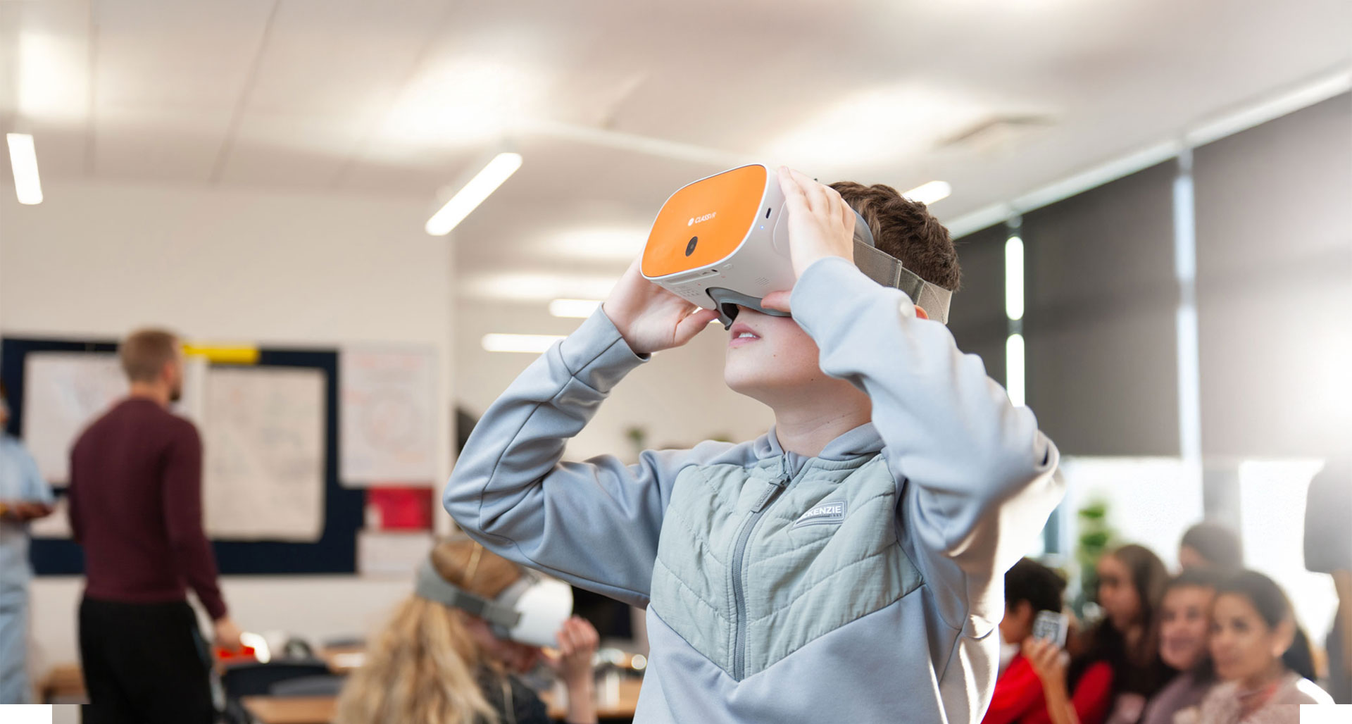 A student engaging with virtual reality technology in a classroom setting, immersed in an educational experience.