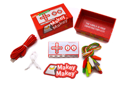 Makey Makey® Classic Invention Literacy Kit with controller board, cables, and accessory items.