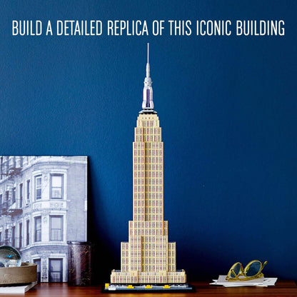 LEGO® Architecture Empire State Building Set 21046 displayed against a blue wall, showcasing its architectural details.