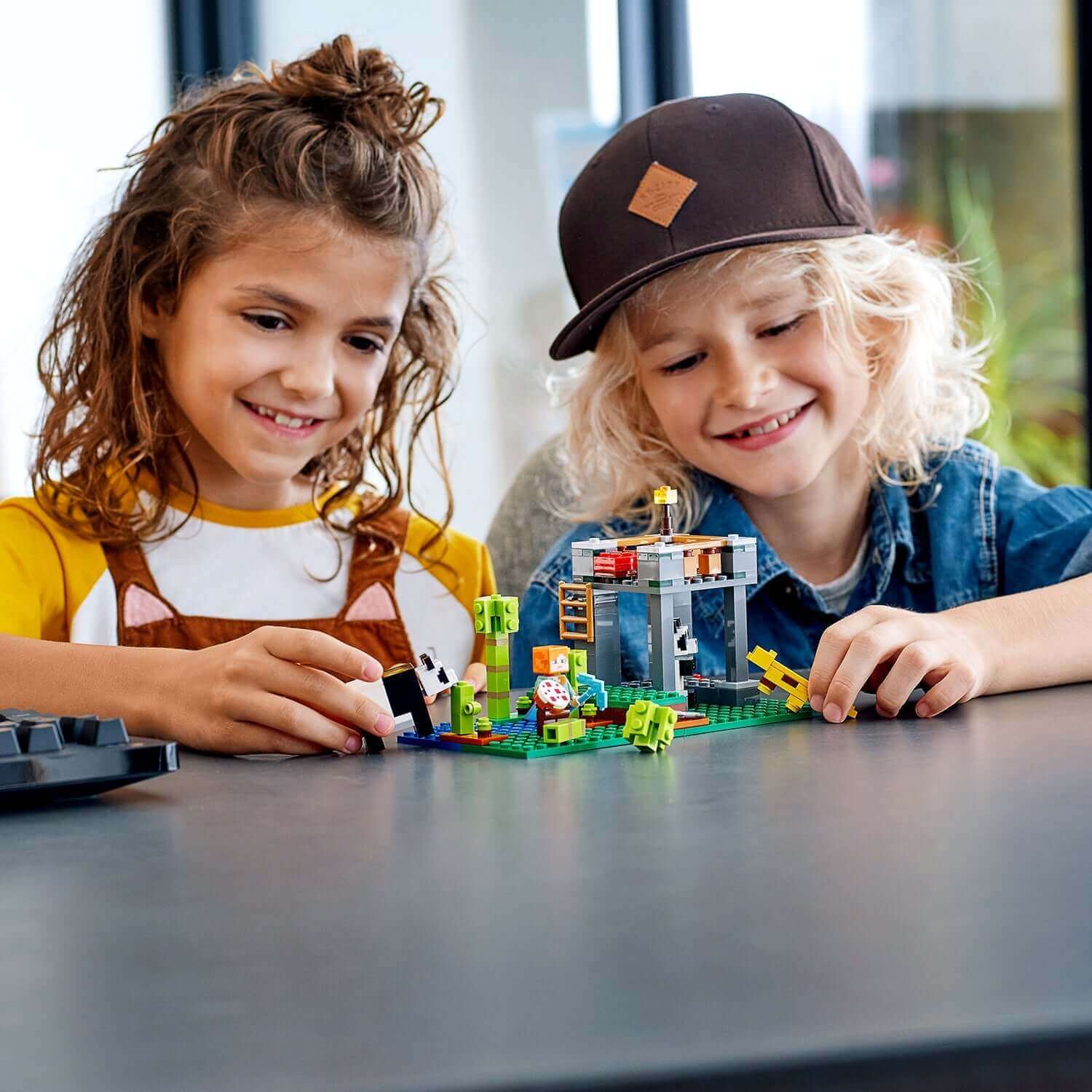 Kids playing with LEGO® Minecraft The Panda Nursery Building Set 21158, featuring pandas and nursery fun.