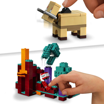 Child interacting with LEGO® Minecraft The Warped Forest toy, featuring a buildable mountain and TNT element.
