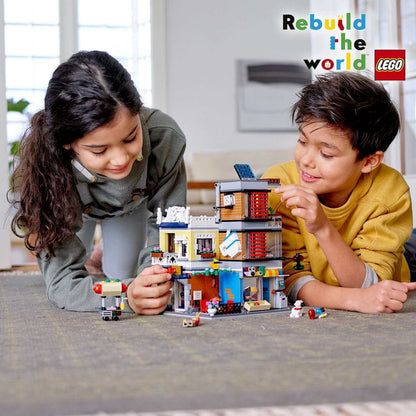 Kids building LEGO Creator 3in1 Townhouse Pet Shop & Café 31097, showcasing creativity and fun in a vibrant setting.