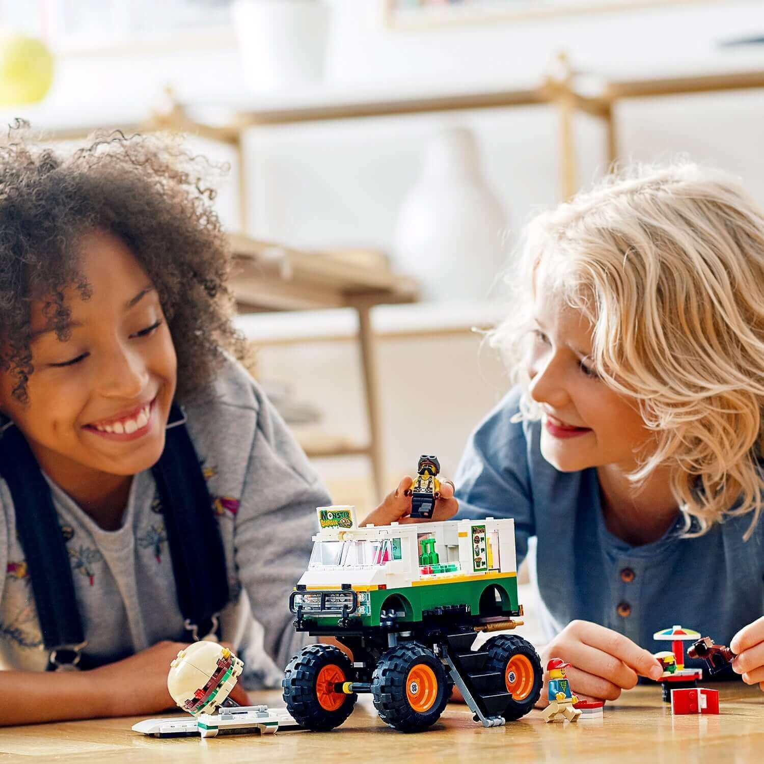 Two kids playing with the LEGO® Creator 3in1 Monster Burger Truck set, enjoying creative building and imaginative play.