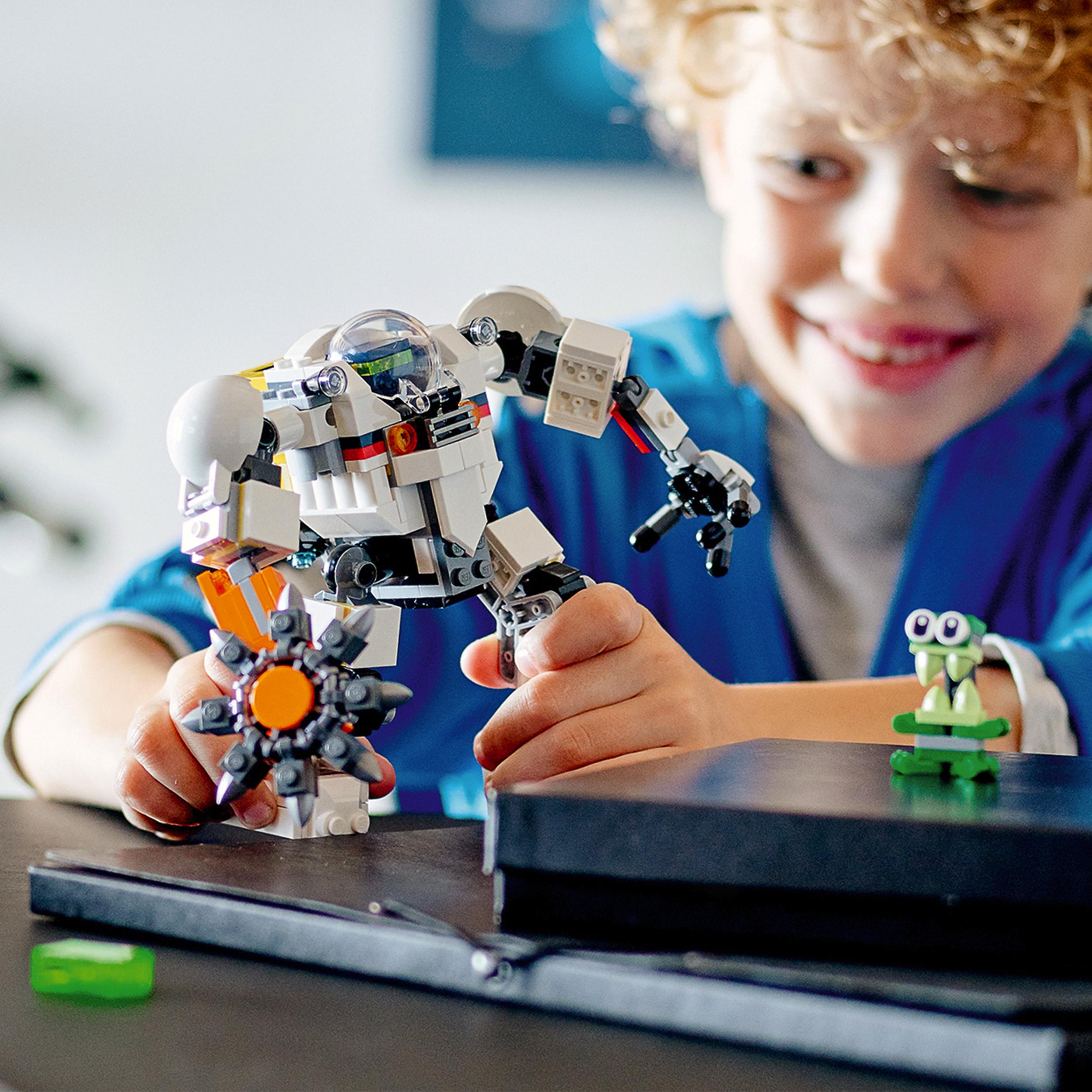 Child playing with LEGO® Creator 3in1 Space Mining Mech toy, showcasing creativity and adventure in space.