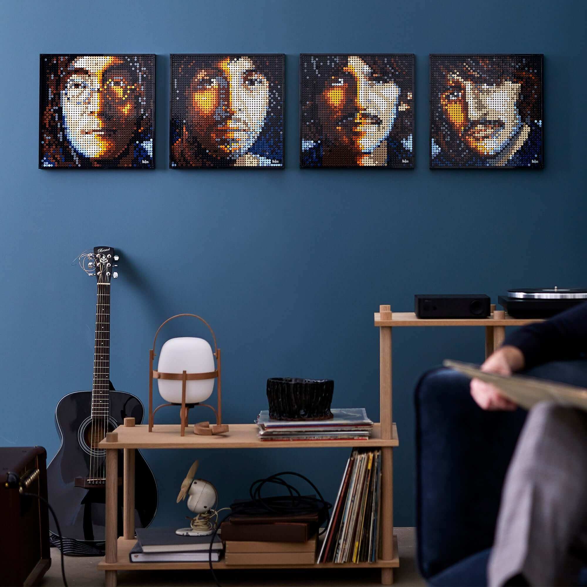 LEGO® Art The Beatles 4in1 wall art displayed in a modern living room with guitar and furniture.
