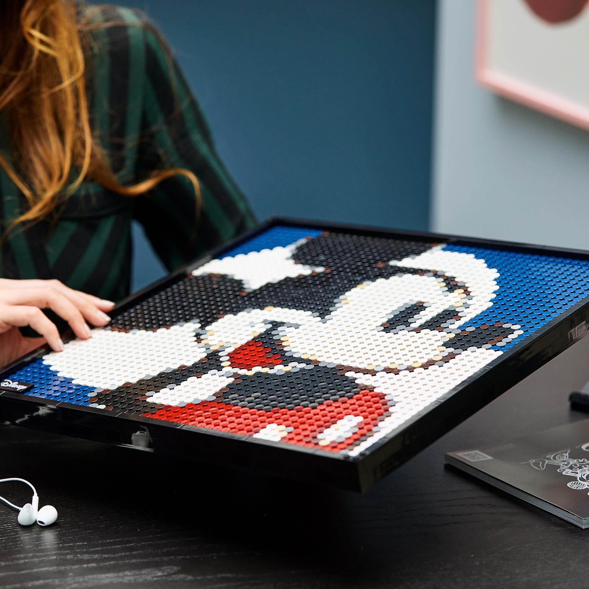 Close-up of LEGO® Art Disney's Mickey Mouse poster set being assembled, showcasing vibrant colors and design details.