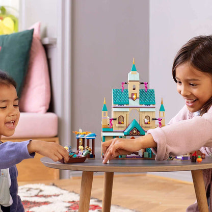 Kids playing with LEGO® Disney Frozen II Arendelle Castle Village 41167 set, featuring Anna and Elsa.