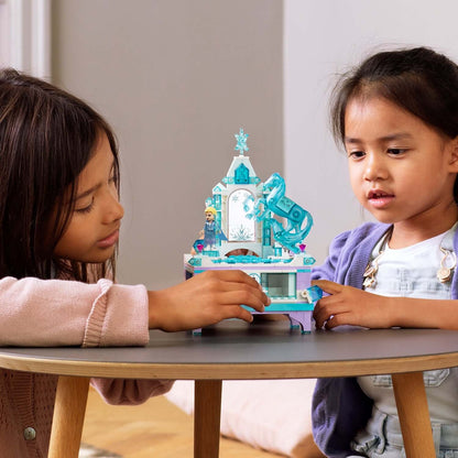 Kids playing with LEGO® Disney Frozen 2 Elsa's Jewellery Box Set 41168 on a table, showcasing creativity and fun.