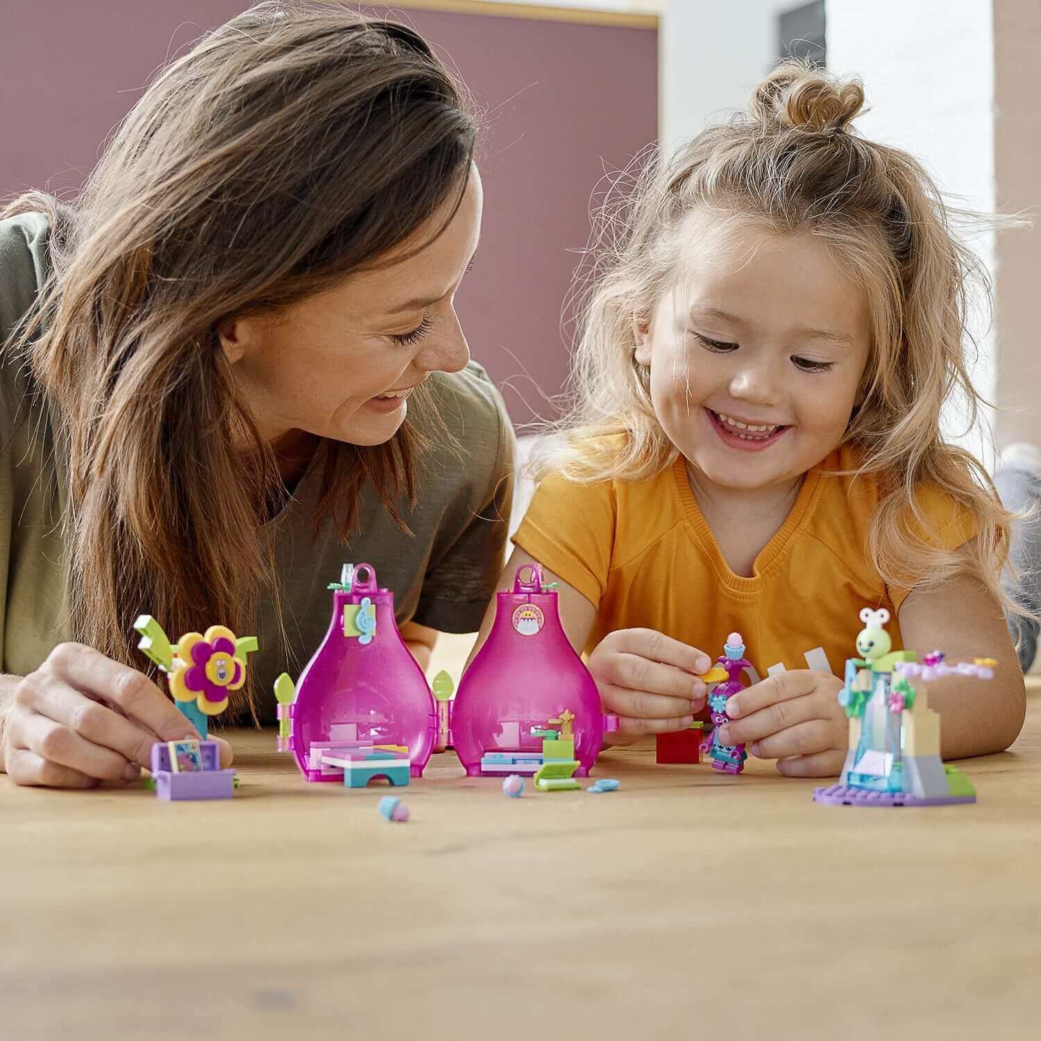 Mom and daughter playing with LEGO® Trolls Poppy’s Pod Travel Set 41251, creating fun scenes together.