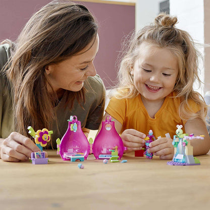 Mom and daughter playing with LEGO® Trolls Poppy’s Pod Storage Travel Set, creating fun movie scenes.