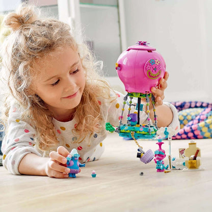 Child playing with LEGO® Trolls Poppy’s Hot Air Balloon Playset 41252, recreating scenes from the TROLLS WORLD TOUR movie.