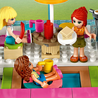 LEGO® Friends Friendship Bus playset featuring friends enjoying snacks by the pool with colorful accessories.