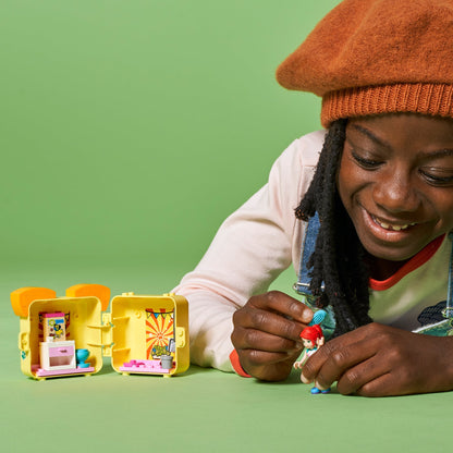 Child playing with LEGO® Friends Mia’s Pug Cube Playset 41664, showcasing colorful portable toy.