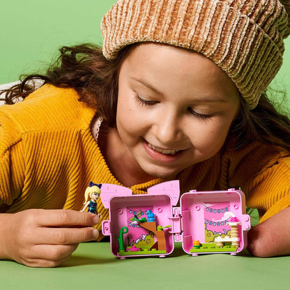 A child happily playing with LEGO® Friends Stephanie's Cat Cube Playset, showcasing the cute minidoll and vibrant interior.