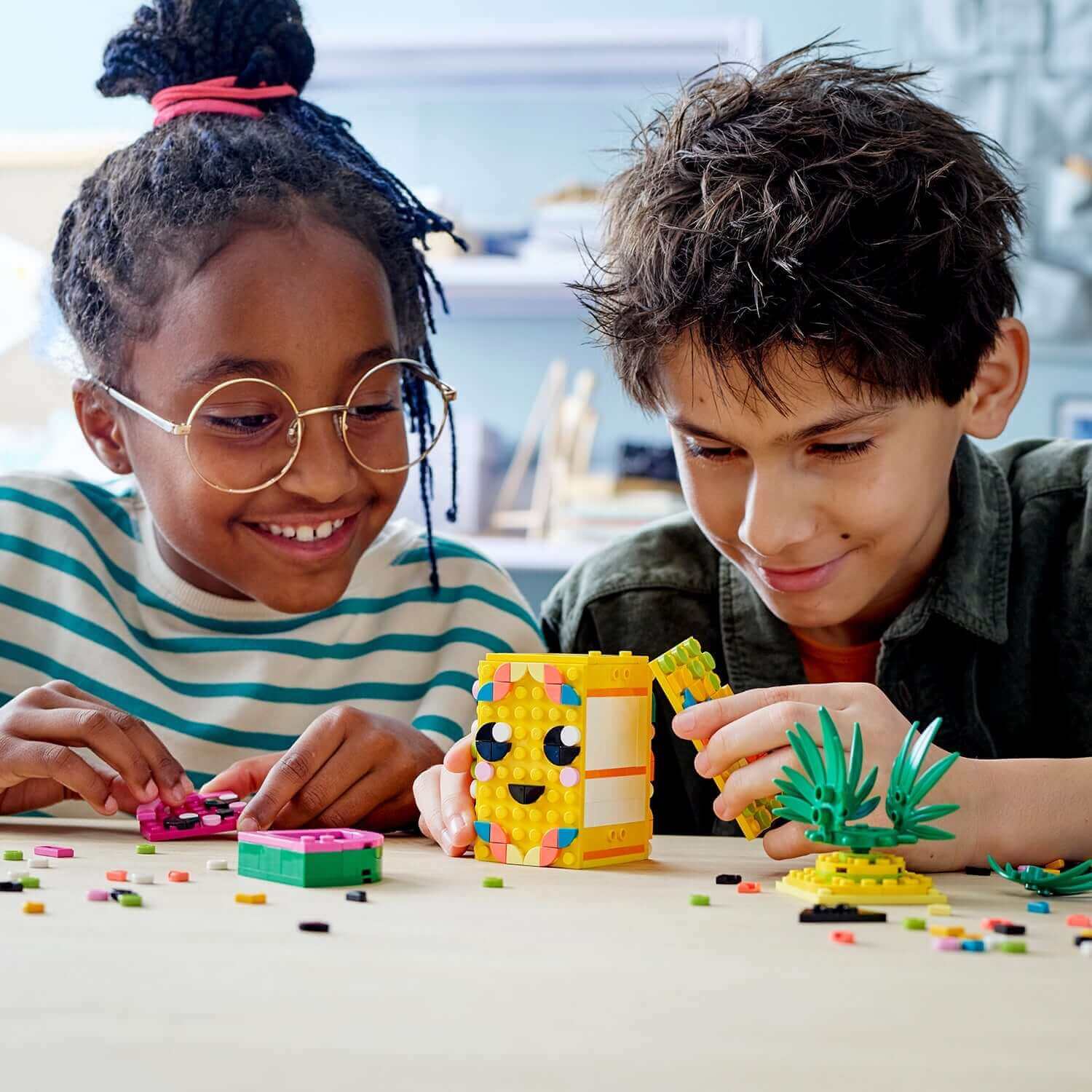 Kids crafting with LEGO® DOTS Pineapple Pencil Holder Crafts Set 41906, showcasing creativity and fun with design.