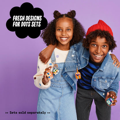 Kids showcasing creativity with LEGO® DOTS designs, wearing decorated keychains and smiling against a purple background.