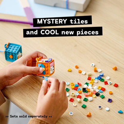 Child crafting with LEGO DOTS tiles, showcasing mystery pieces and colorful tiles on a wooden table.