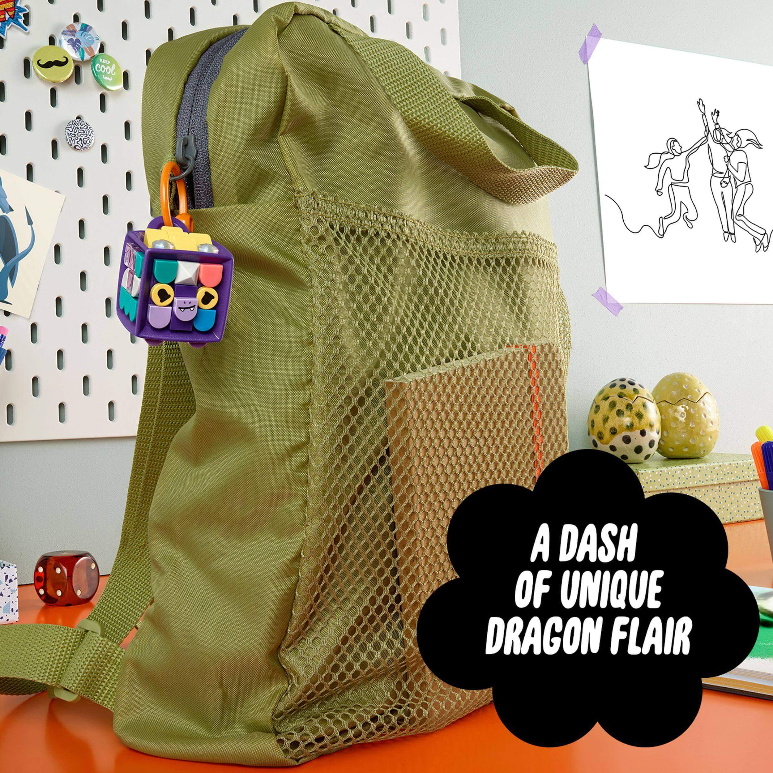 LEGO DOTS Bag Tag Dragon arts & crafts set adding unique flair to a green backpack, featuring customizable accessories and bright colors.