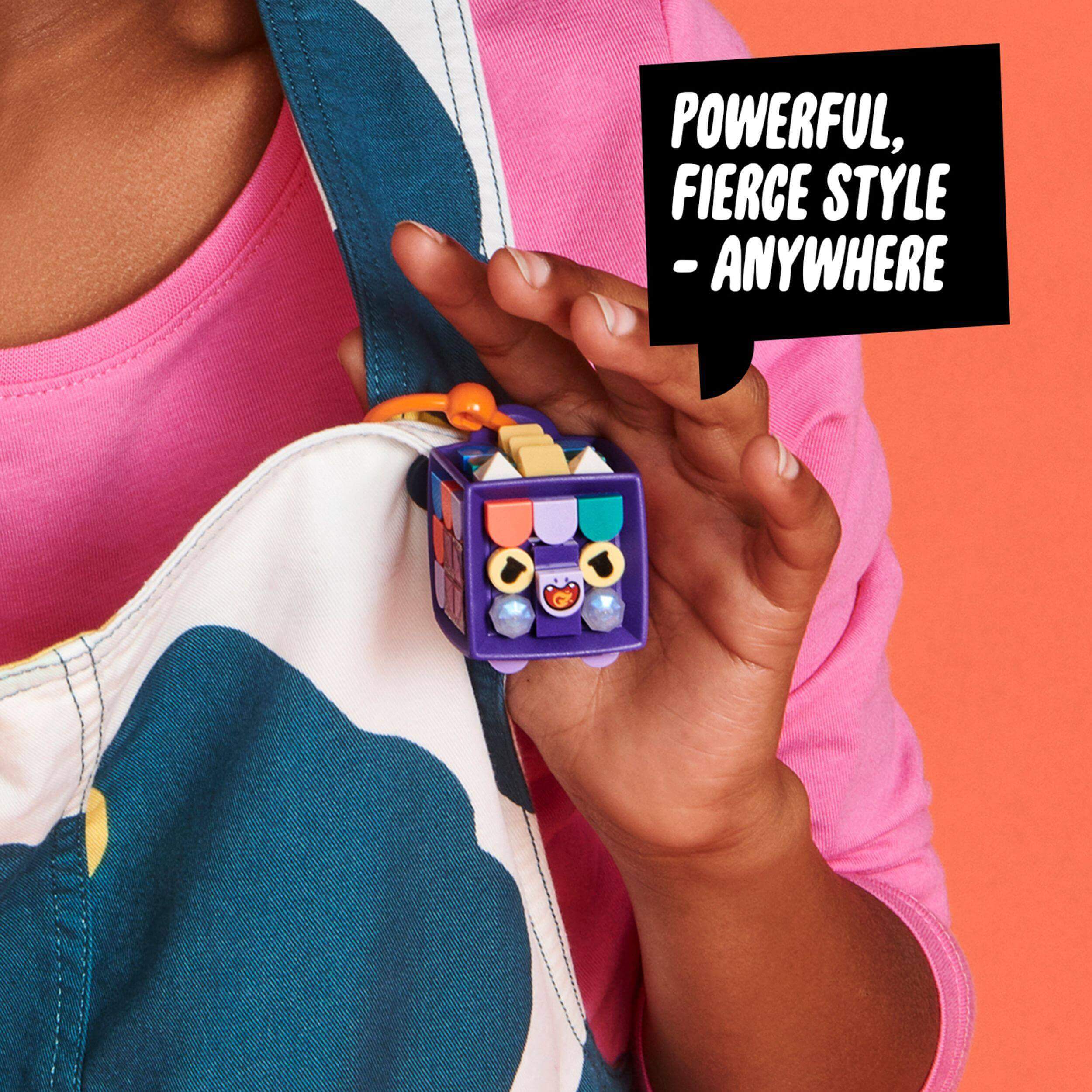 Customizable LEGO® DOTS Bag Tag Dragon, showcasing purple cube attachment on a colorful outfit.