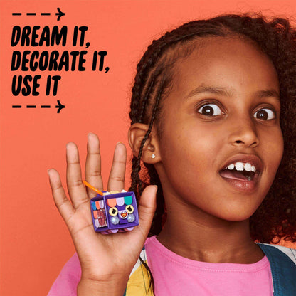 Child showcasing the LEGO® DOTS Bag Tag Dragon kit, emphasizing creativity with customizable decorations.