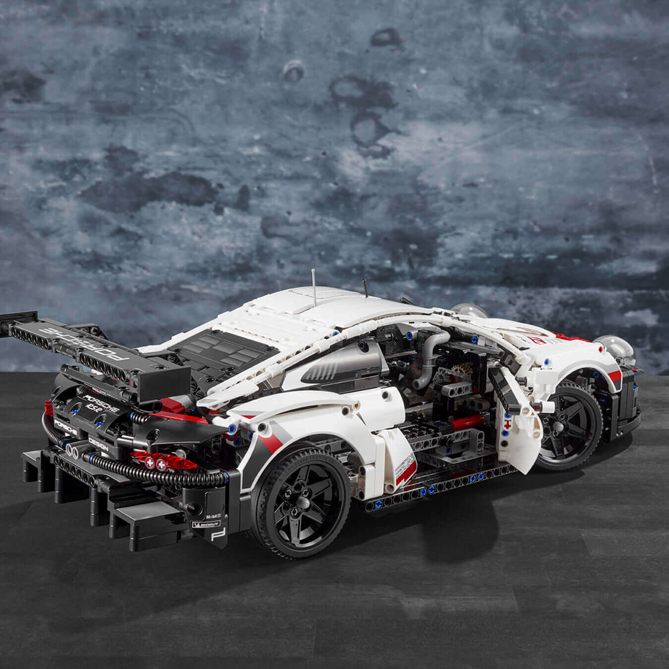 LEGO Technic Porsche 911 RSR model car kit with detailed engine and working features, showcasing realistic design.