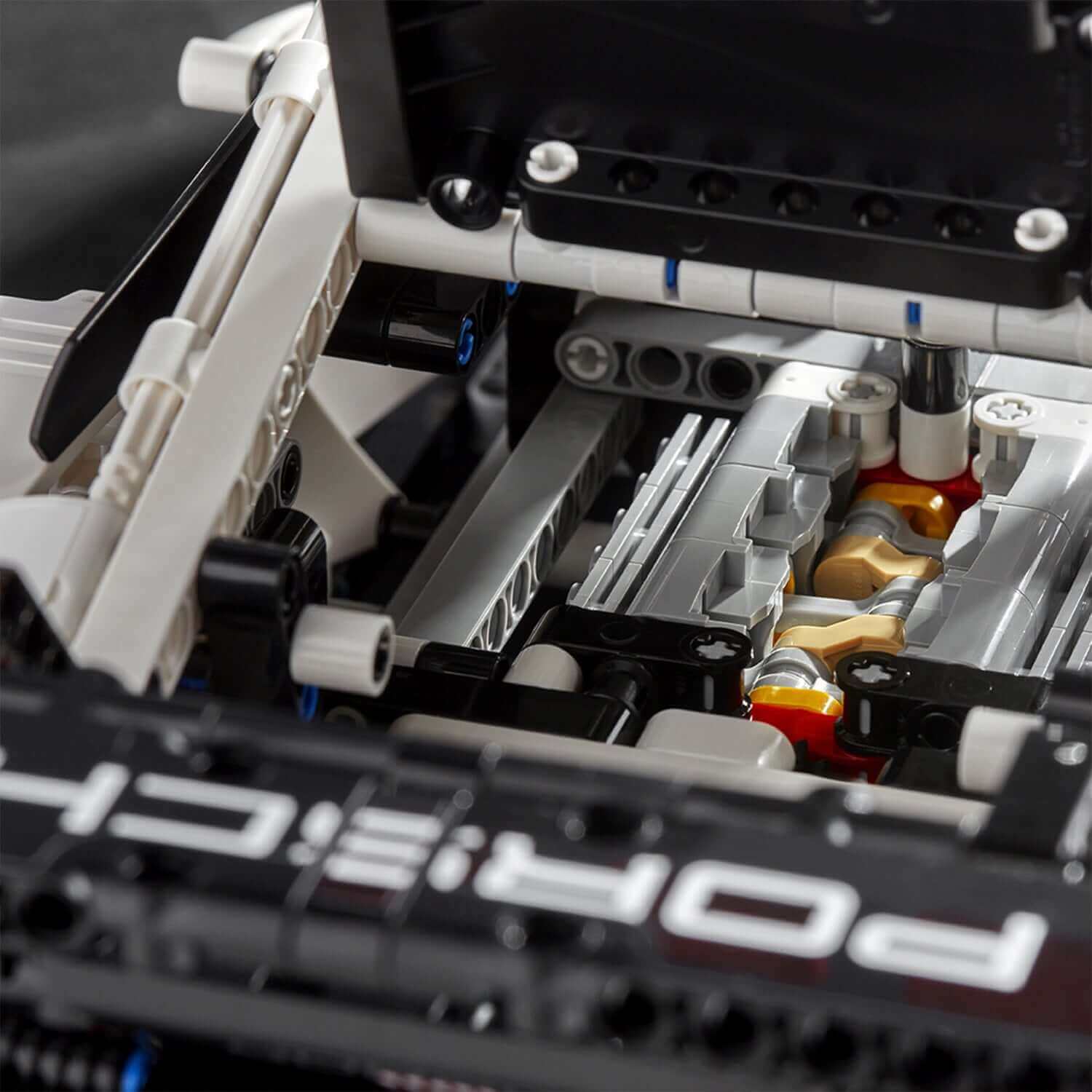 Close-up view of LEGO® Technic Porsche 911 RSR engine, showcasing detailed six-cylinder boxer engine components.