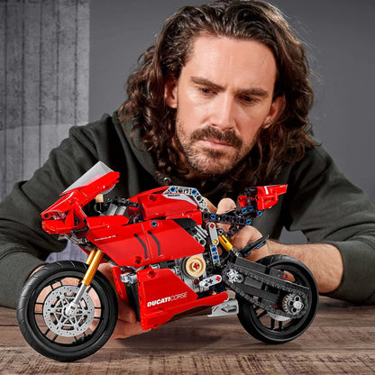 Person examining the LEGO® Technic Ducati Panigale V4 R model set 42107 with detailed features and vibrant colors.