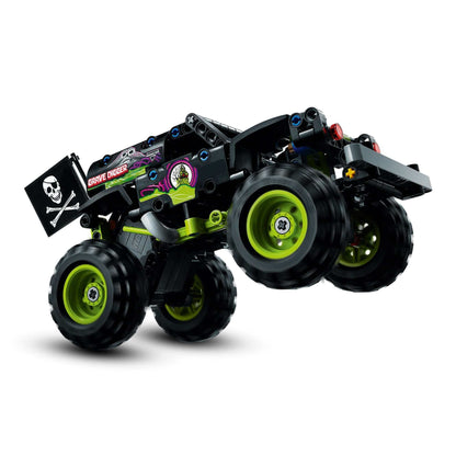 LEGO Technic Monster Jam Grave Digger truck model in mid-air, showcasing its wheels and design features.