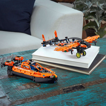 LEGO® Technic 2-in-1 Rescue Hovercraft Model Toy 42120 displayed on a table with books, showcasing its vibrant orange design.