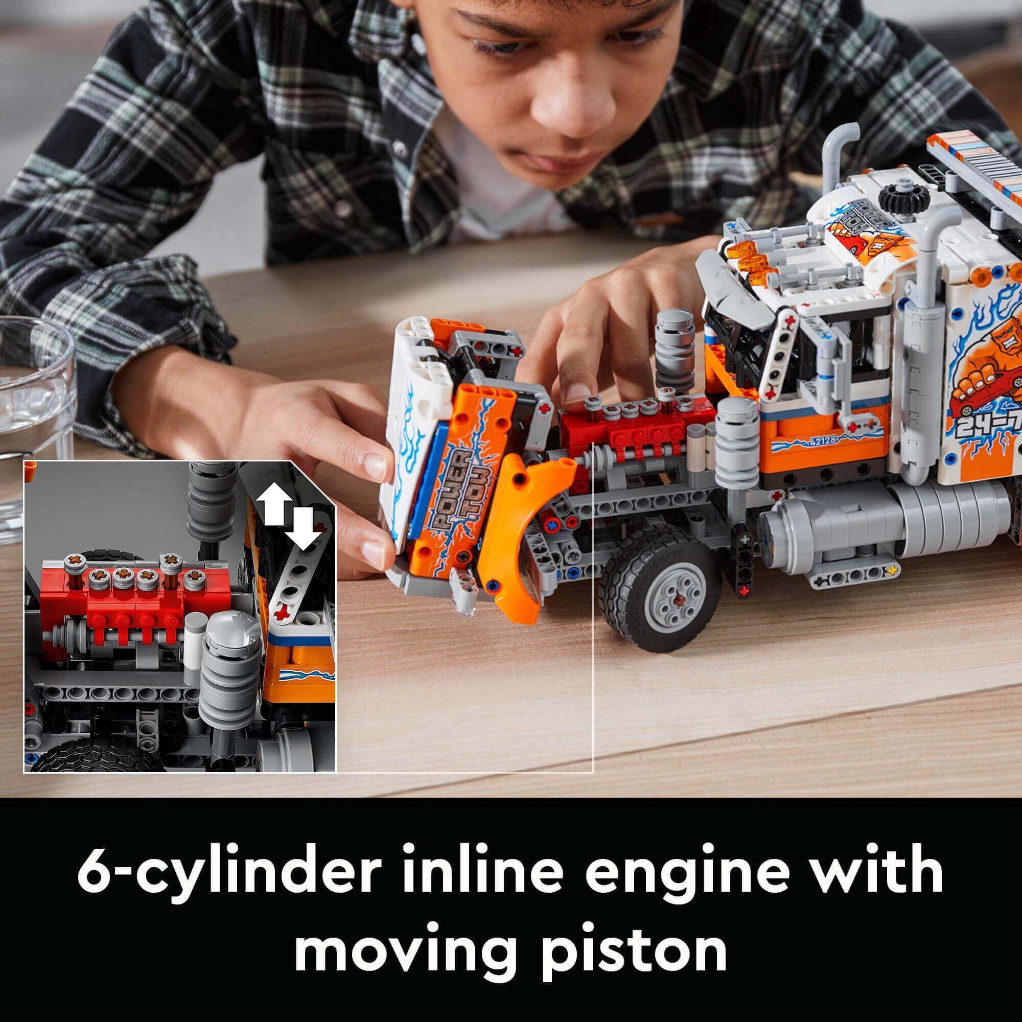 Child building LEGO® Technic Heavy-Duty Tow Truck with 6-cylinder inline engine and moving piston features.