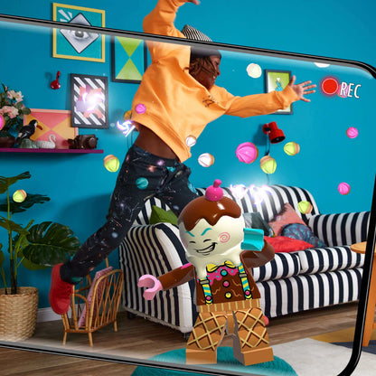 Child dancing with LEGO® VIDIYO™ Bandmates minifigure in a colorful living room setting.