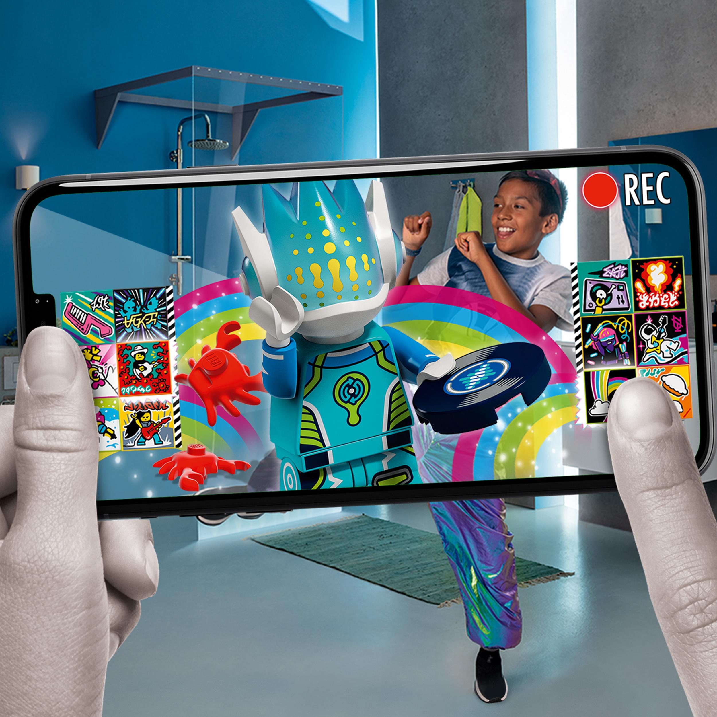 Child filming a fun music video with LEGO® VIDIYO Alien DJ BeatBox set on smartphone, featuring colorful animations.