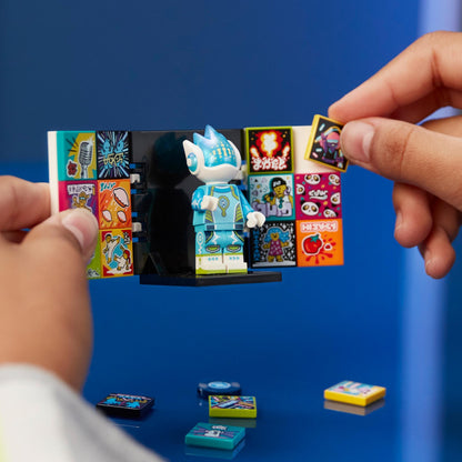 Child placing music stickers on LEGO® VIDIYO Alien DJ BeatBox set for creative music videos.