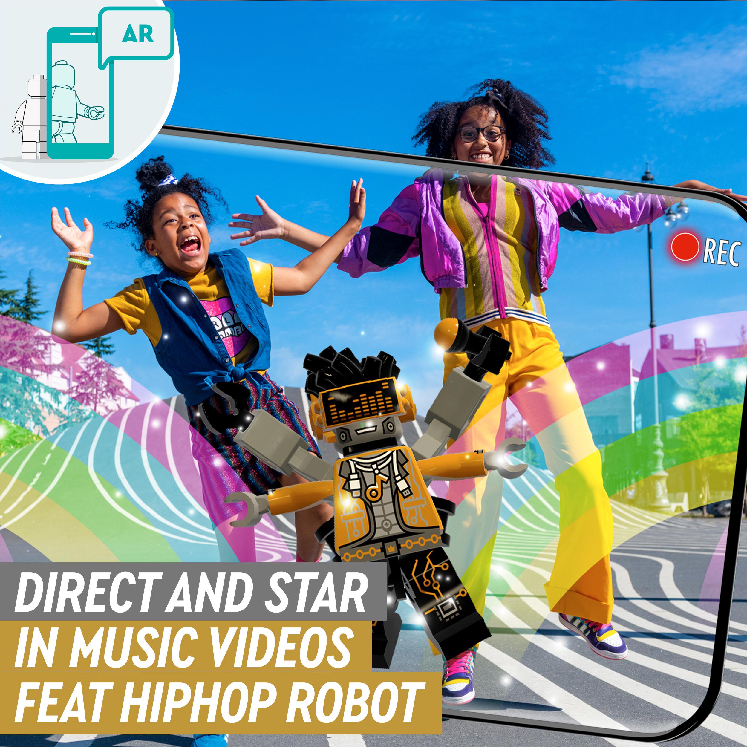 Kids dancing with LEGO® VIDIYO HipHop Robot while filming creative music videos outdoors.