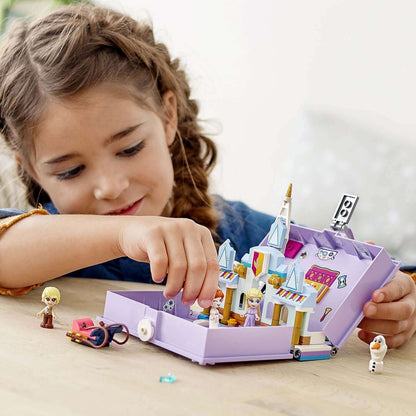 Child playing with LEGO® Disney Frozen II Anna and Elsa’s Storybook 43175 micro-world toy set.